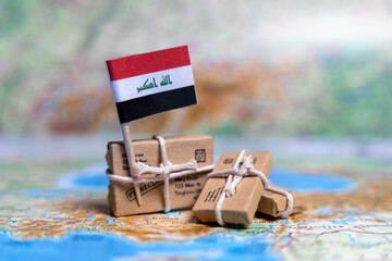 Flag of Iraq near the parcels on the world map. World trade. Exports and imports of goods. Economy of the country.
