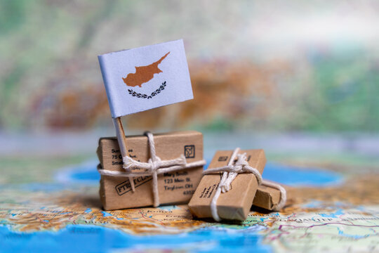 Flag of Cyprus near the parcels on the world map. World trade. Exports and imports of goods. Economy of the country