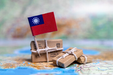 Flag of Taiwan near the parcels on the world map. World trade. Exports and imports of goods. Economy of the country