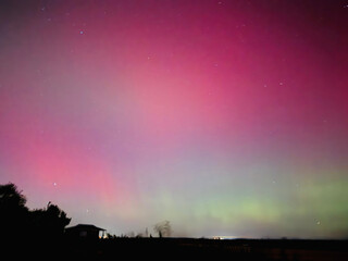 Stunning, dreamy display of vivid colors seen from aurora borealis, northern lights over Long...
