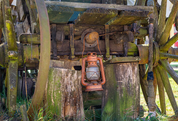 old red kerosene lamp hanging on an old horse cart on a pumpkin farm. wild west © Adam