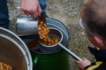 Preparing crispy cracklings with pork fat, food concept