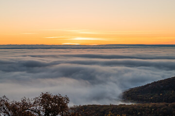 Wintergreen Resort, Virginia sunrise of sun behind clouds mist fog above Blue Ridge mountains in autumn fall