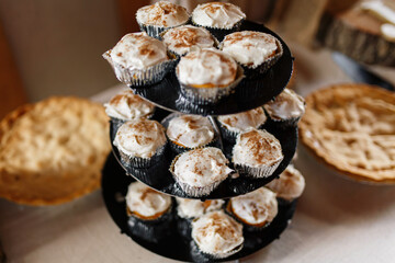 Cupcake Stand With Frosted Cupcakes Beside A Pie