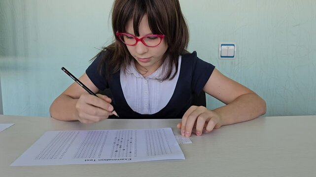 Schoolgirl cheating on exams at school and cheating on a cheat sheet concept
