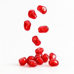 red pomegranate seeds falling on white background