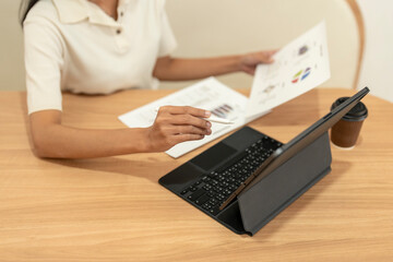 Business woman analyzing financial chart using digital tablet and pen in office