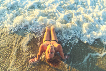 View of beautiful female on beach enjoying the waves