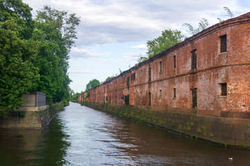 Obvodny Canal in Kronstadt, view of old drainage canal with an abandoned warehouse building on the...