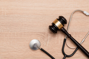 Judge gavel and stethoscope on wooden background, The law in medicine and medical negligence concept