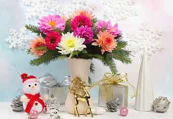 Christmas creative bouquet of live fir branches in vase with chrysanthemum flowers and handmade decorations on elegant festive background. Christmas and New Year eco mockup for design 