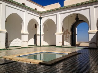 Courtyard of the Sidi Boumediene mosque with a basin of water for ablutions,  it's arches and old...