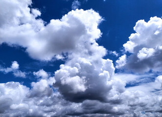 Clear blue sky texture and white fluffy cloud nature background. The sun shines bright in the daytime in summer
