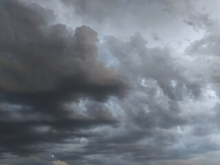 Dramatic cloud formation fills the sky during an overcast evening, hinting at an approaching storm