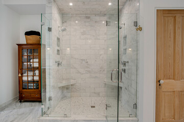 Luxurious Marble Shower With Dual Glass Doors.