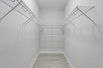 White Walk-In Closet With Organized Wire Shelving Units.
