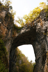 Majestic Natural Rock Bridge With Vibrant Autumn Trees