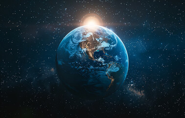 Fototapeta premium Dawn breaks over Earth from space A breathtaking view of Earth in space as dawn breaks, illuminating the planet's surface against a backdrop of stars.