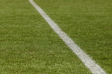 Football field with synthetic grass, with its white diagonal lines.