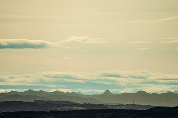 A beautifully cloudy sky with majestic mountains in the background