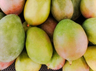 Closeup detail of texture surface background of the mango stock at the fruit stand.