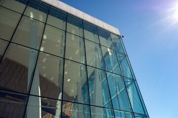 Obraz premium Exterior of Oslo Opera (Operataket) building, support columns and window, sun flare