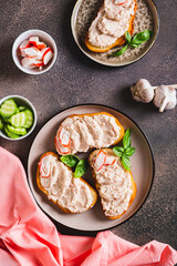 Delicious sandwiches with crab meat and cucumber pate on a plate top and vertical view