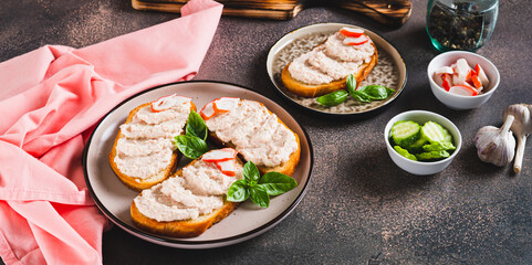 Crab stick and cucumber pate on toast on a plate on the table web banner