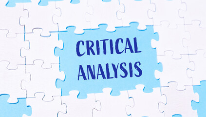 Fototapeta premium Puzzle with the word critical analysis written in blue