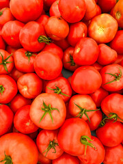 Tomato background. Fresh organic tomatoes on a street farmers market market in London. Heritage heirloom tomatoes. Colourful. Full frame