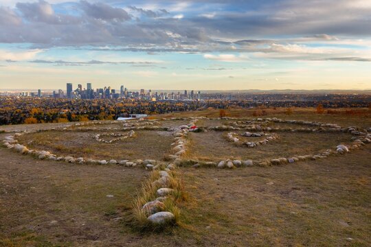 Nose Hill Urban Park Siksikaitsitapi Medicine Wheel.  Blackfoot Tribe First Nations Munument Calgary City Skyline.  Alberta Canada Prairie Landscape