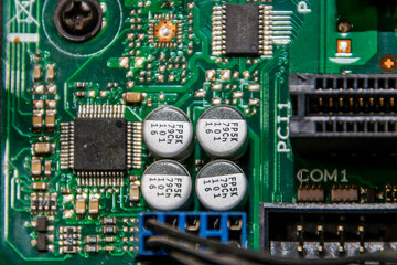 Boards and microcircuits with capacitors inside a computer with inscriptions	
