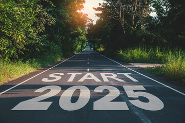 New year 2025, Text start 2025 written on the road in the middle of asphalt road at sunset. Concept...