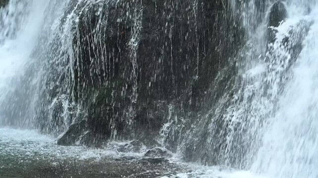 The lower part of a waterfall with mossy stones in autumn, slow motion, Josefsthaler Wasserf&auml;lle