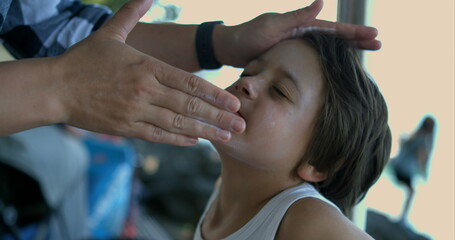 Applying sunscreen to a child's face in slow motion at 800 fps, emphasizing the gentle care and...