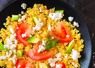 Fresh bulgur salad with tomatoes, avocado and feta cheese. Vegetarian salad with bulgur