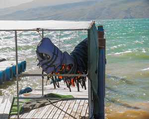 life jackets hang on the pier against the background of the Chirkeysky reservoir