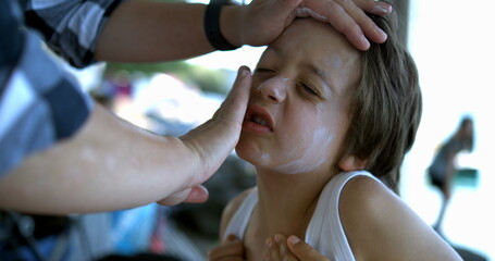 Sunscreen being spread on a child's face in slow motion at 800 fps, highlighting the detailed care...