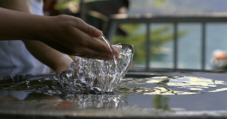 Hand creating a dramatic water splash in slow motion at 800 fps, highlighting the energy and dynamic movement in the interaction with water