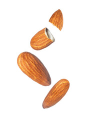 Whole and cracked dried almonds close-up on a transparent background