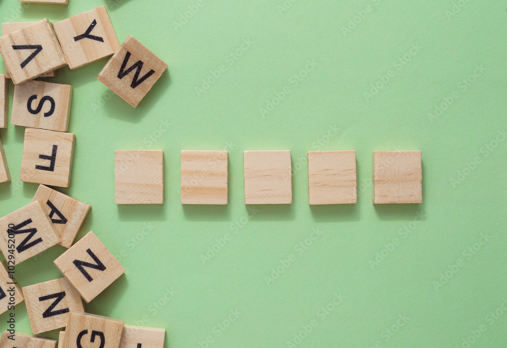 Poster a row of wooden blocks with letters on them, neatly aligned