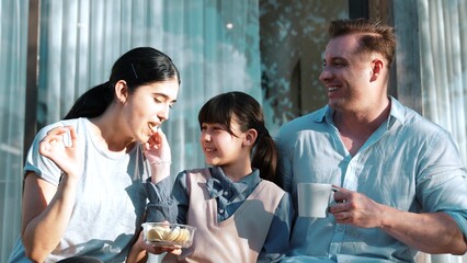 Lovely marriage couple and daughter picnic at outdoor terrace. Family using outdoor activity show love and care to strengthen good growth for child, strong family bond or relationship. Divergence.