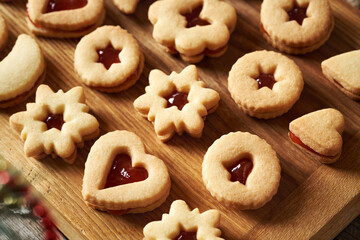 Homemade Linzer Christmas cookies filled with strawberry marmalade