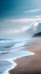 A long exposure photograph of the beach. The ocean is calm and blue, with some fog on top