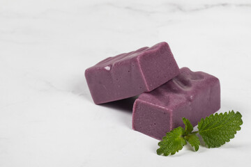 Black grape nougat. White background. Copy space
