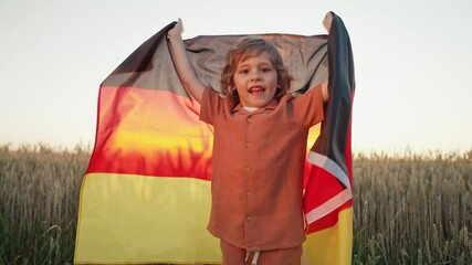 German Little Boy Jumps With Deutschland National Flag. Patriotism. Colors of Germany, Happy future.