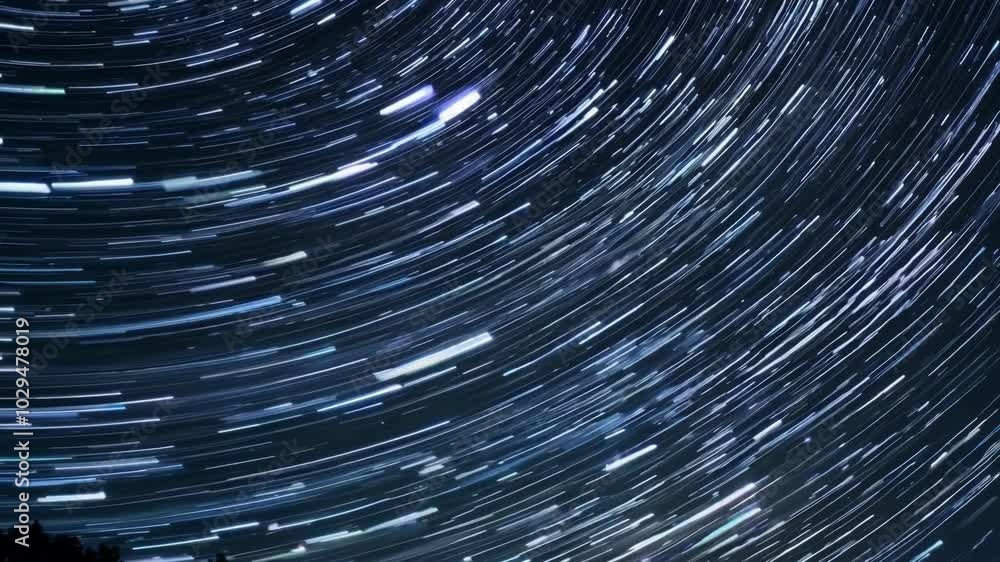 Poster Long exposure showing the apparent movement of the stars in the night sky as bright trails, creating concentric circles around the north celestial pole