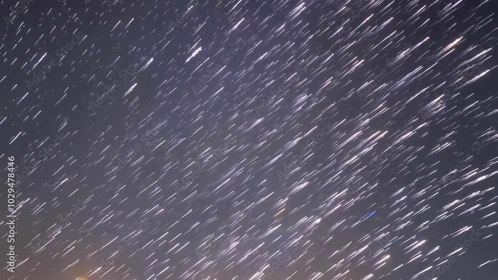 Poster Long exposure creating star trails streaking across the night sky, evoking a sense of movement and the vastness of space