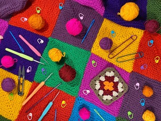 Clews and needle objects for knitting and crocheting on patchwork knitted blanket hobby handmade...