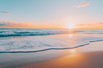 Fototapeta premium A serene early morning sunrise illuminating gentle ocean waves on a sandy beach.